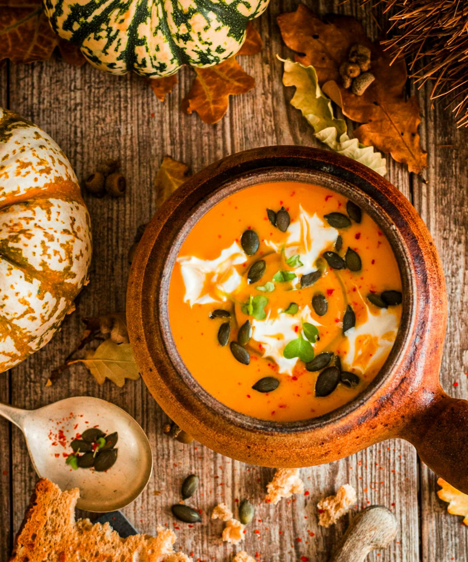 a bowl of soup with pumpkins and other autumn foods